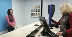 Woman poses for a driver's license photo at Kennewick DOL office.