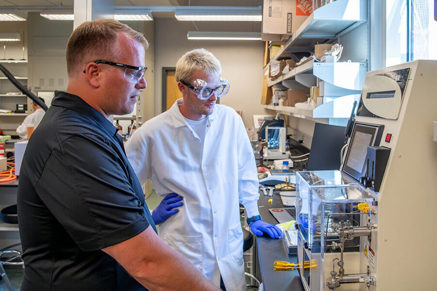 Two researchers viewing a monitor.